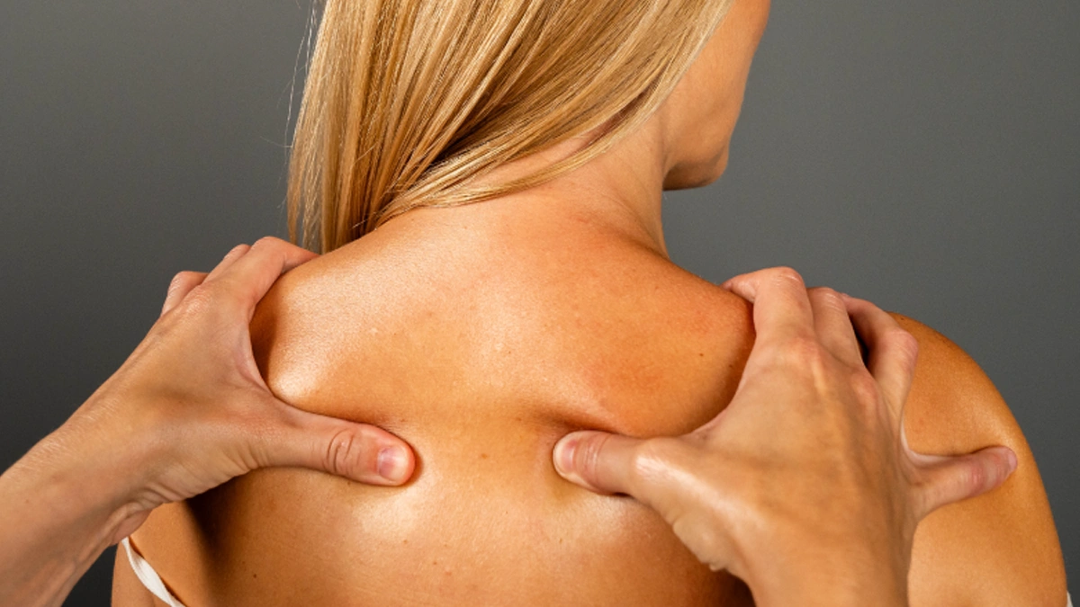 Massage to release knots in shoulder blades