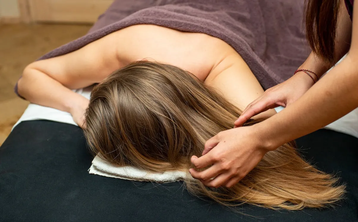 Woman receives relaxation full body massage