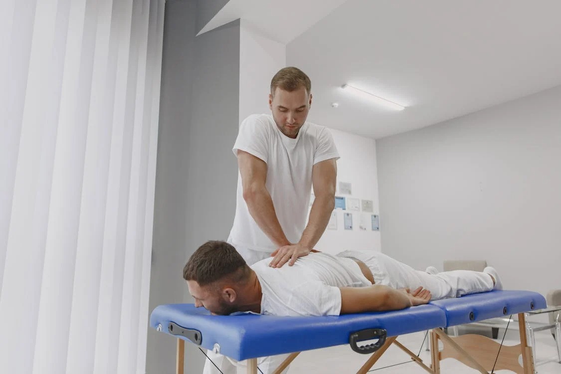 Man receives back massage for easing back pain