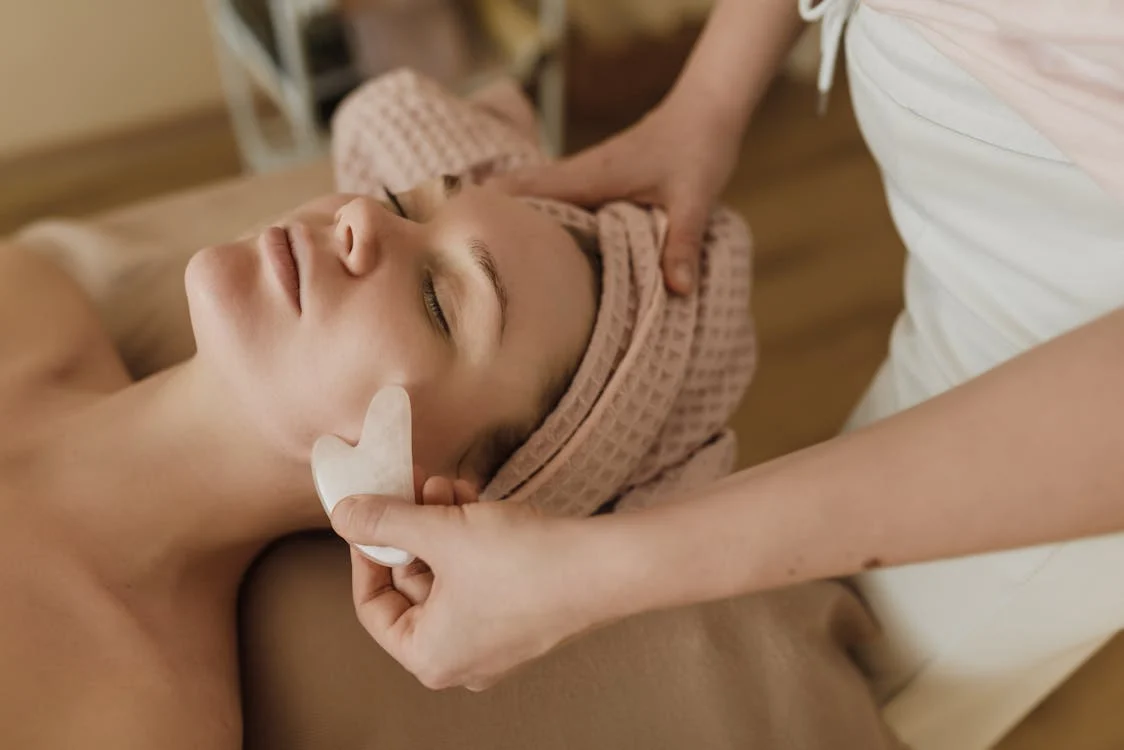 Woman enjoying a gua sha massage session!