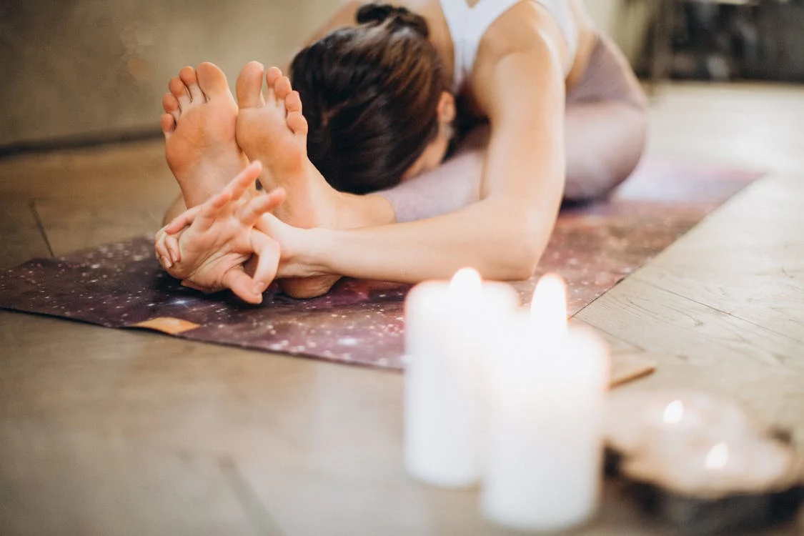 Woman doing a stretching session on a yoga mat