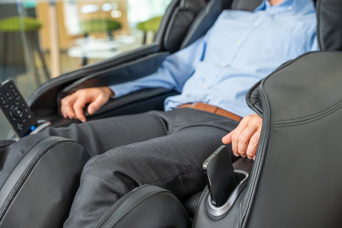 Man benefits from a therapeutic massage on a leather massage chair