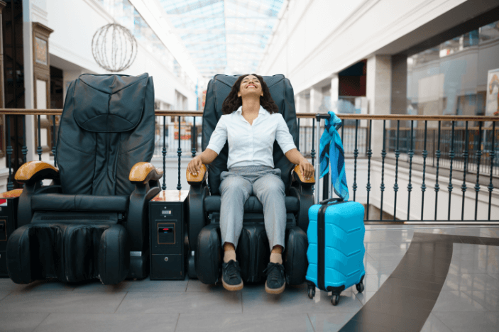 Girl-with-suitcase-relax-in-massage-chair-airport!