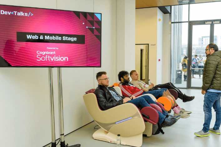 Guys relaxing while using massage chairs