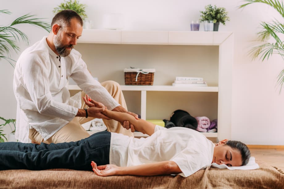 The massage therapist provides a hand massage